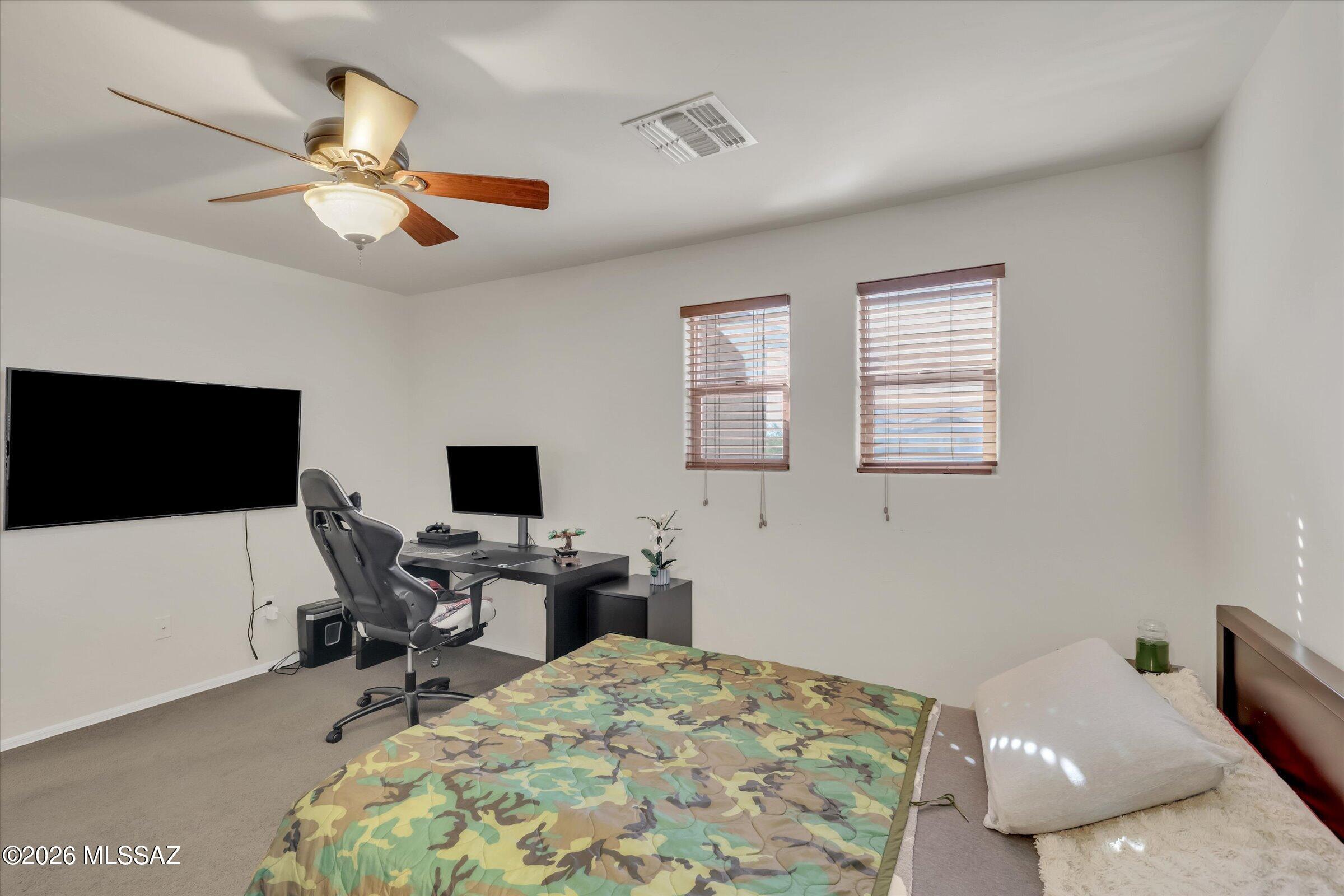6095 South Jakemp Trail Tucson, AZ 85747 - Photo 39 of 52 a bedroom with a workspace