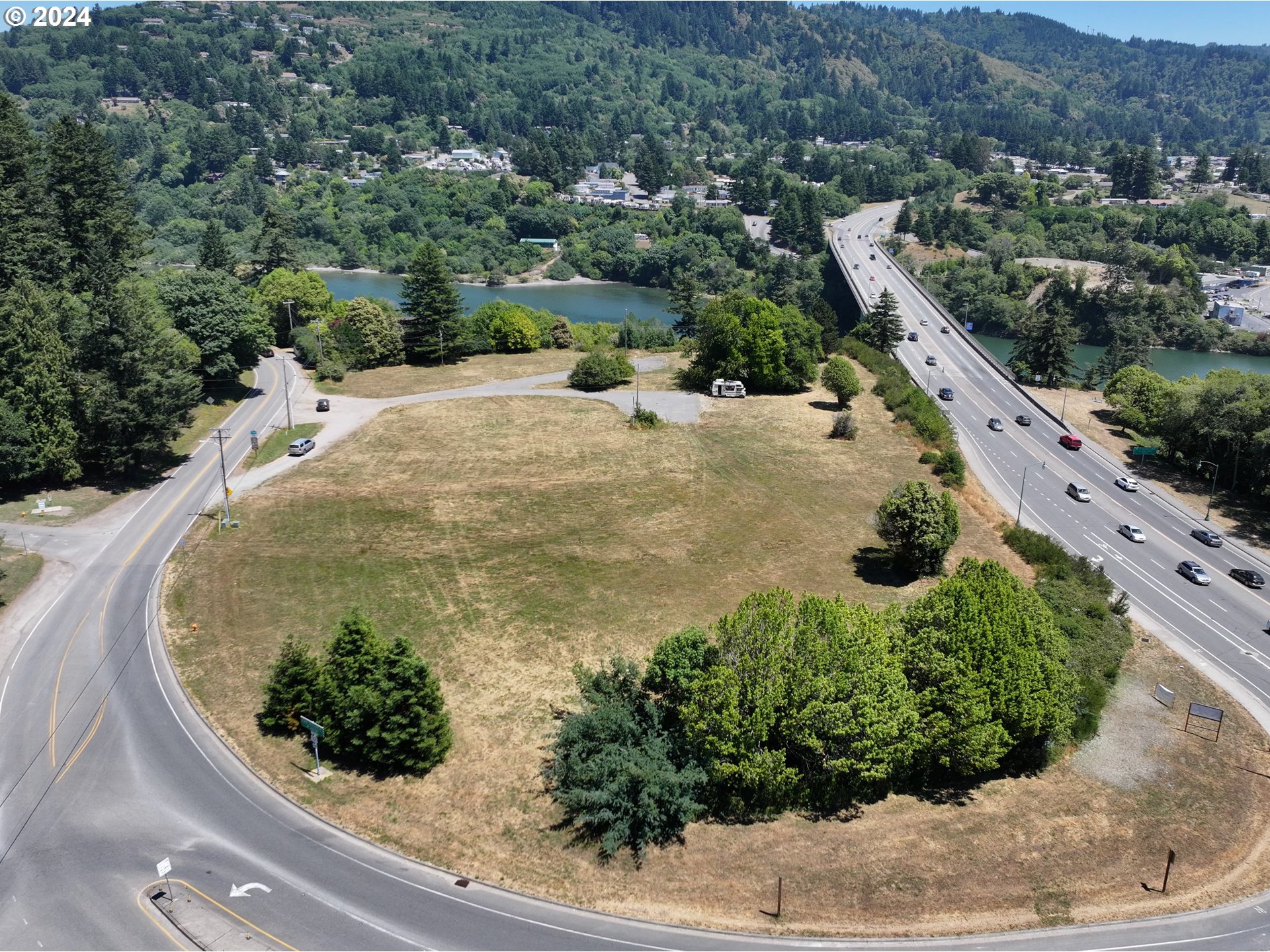 205 North Bank Chetco River Road Brookings, OR 97415 - Photo 3 of 6 an aerial view of a house with a yard