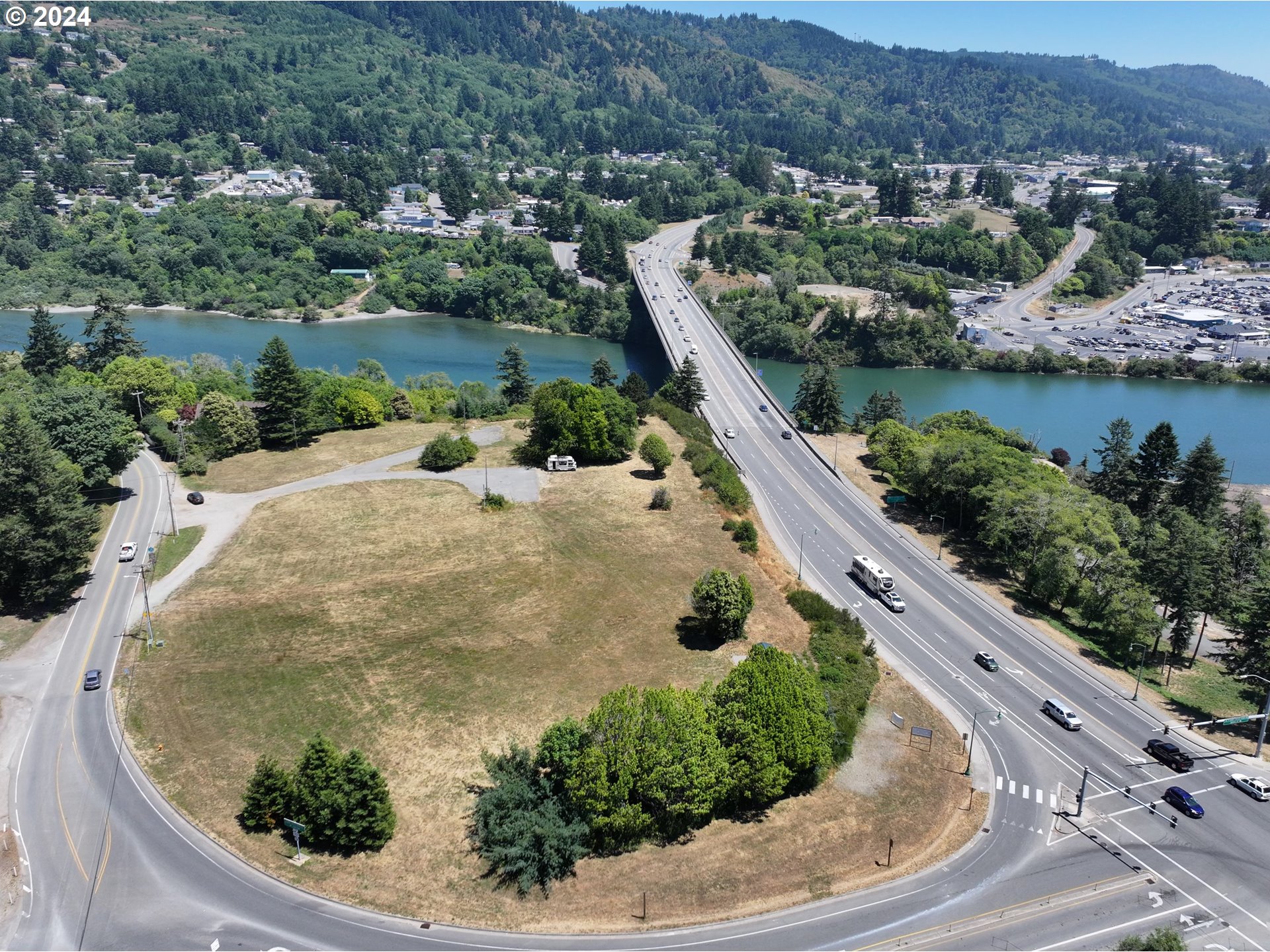 205 North Bank Chetco River Road Brookings, OR 97415 - Photo 5 of 6 an aerial view of a house with a yard and lake view