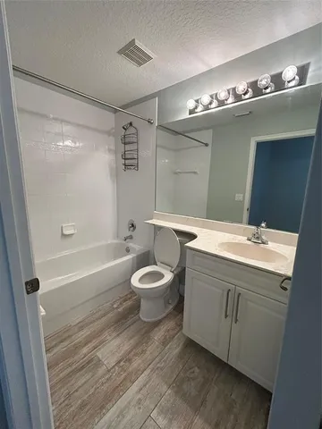 a bathroom with a toilet a sink and bathtub