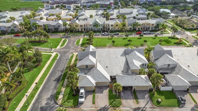 an aerial view of residential houses with outdoor space and street view