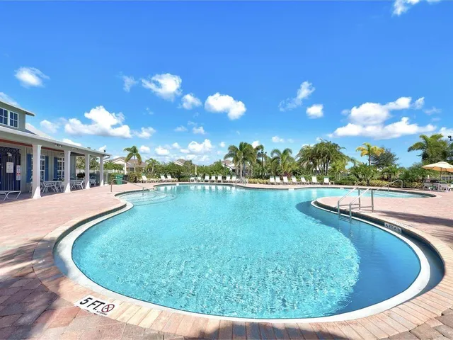 a view of a swimming pool with outdoor seating