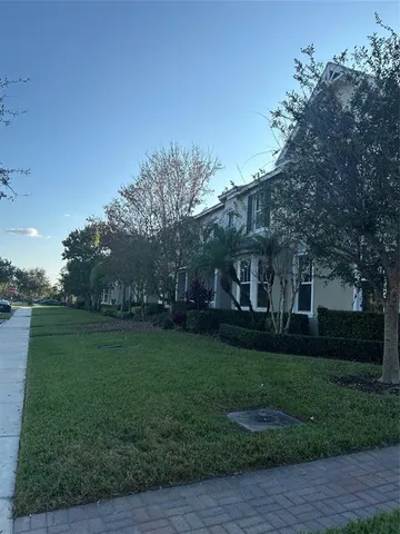 a view of a big yard with a house in the background