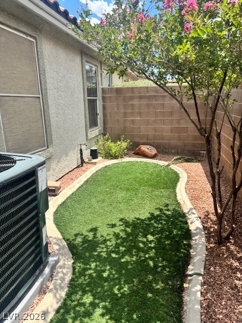 117 Tapatio Street Henderson, NV 89074 - Photo 13 of 14 This private yard offers a blend of natural foliage and manicured landscaping, ideal for outdoor enjoyment.
