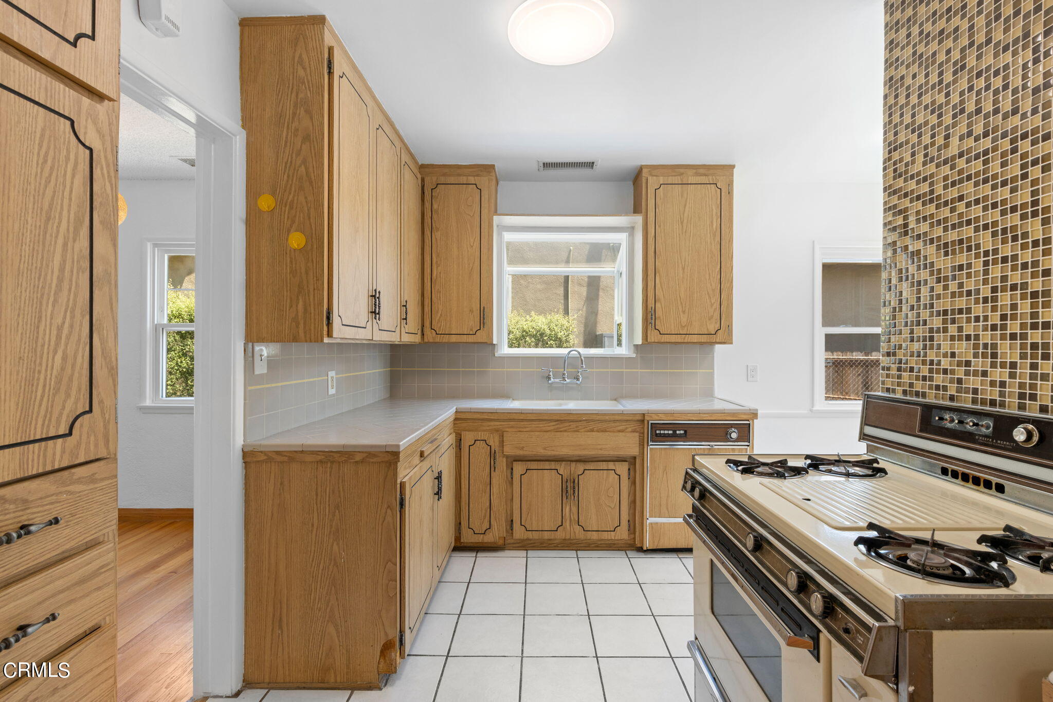 50 Marathon Road Altadena, CA 91001 - Photo 14 of 33 a kitchen with a stove sink and cabinets