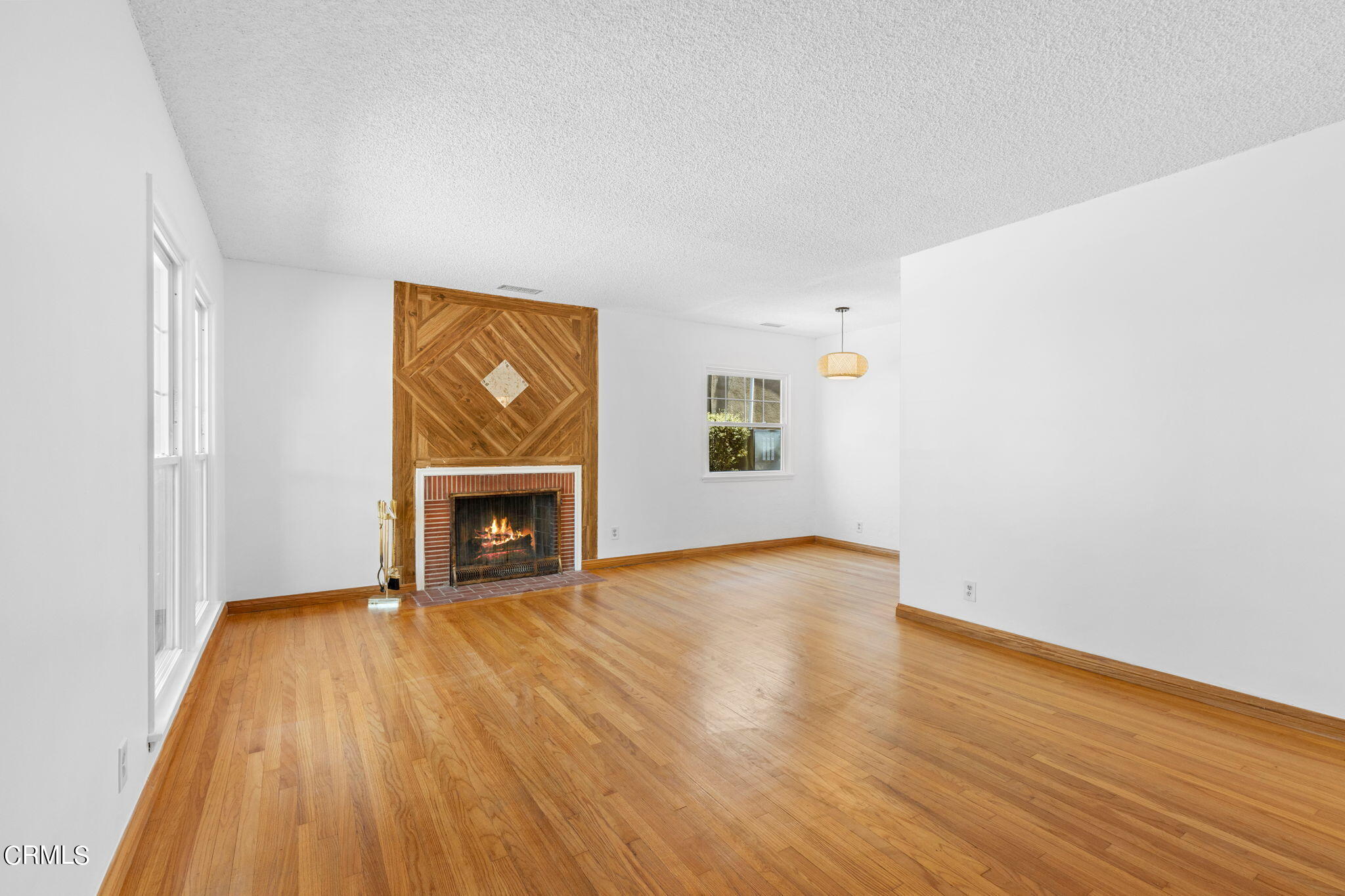 50 Marathon Road Altadena, CA 91001 - Photo 6 of 33 a view of an empty room with wooden floor fireplace and a window