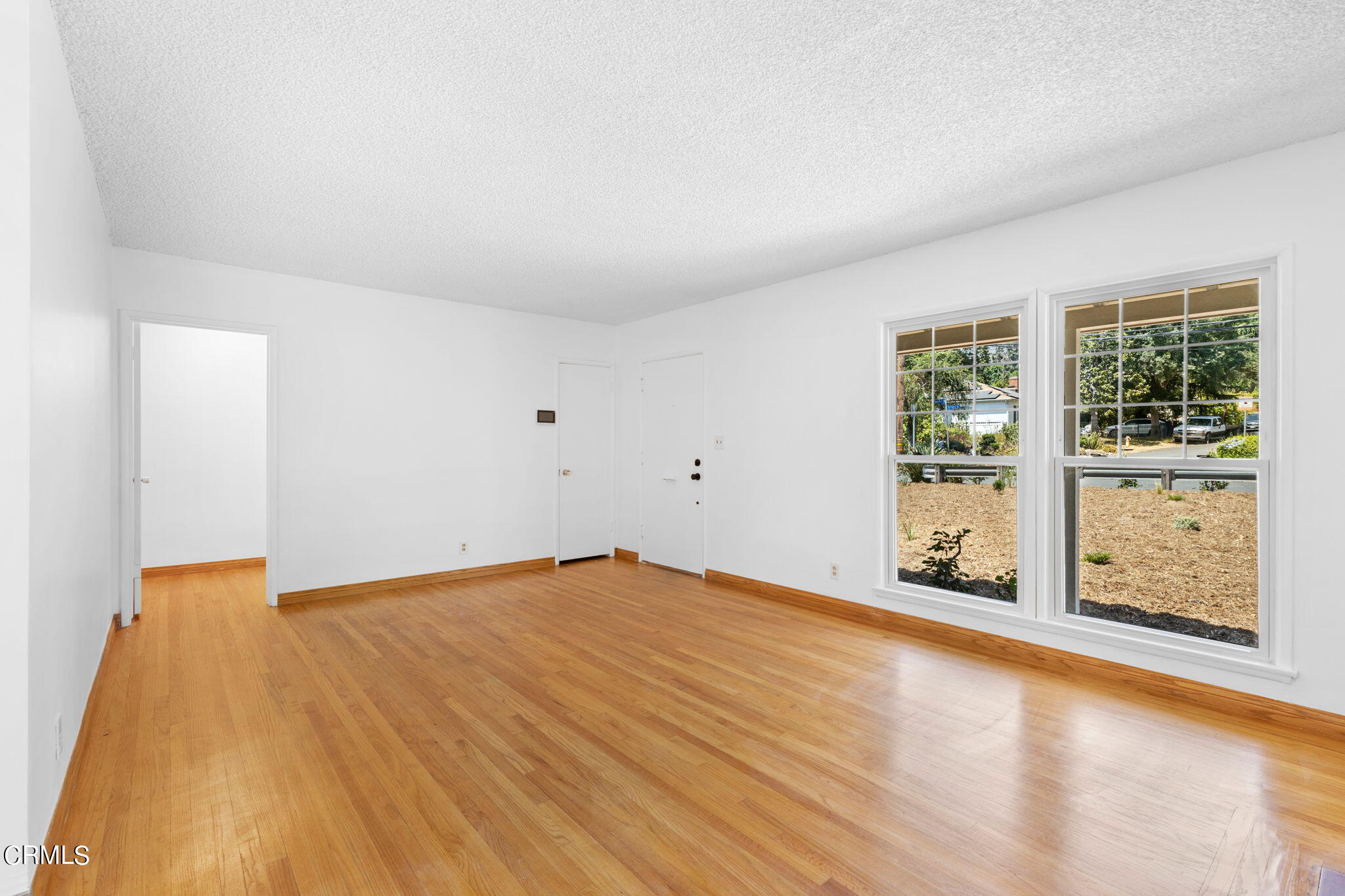 50 Marathon Road Altadena, CA 91001 - Photo 8 of 33 an empty room with wooden floor and windows