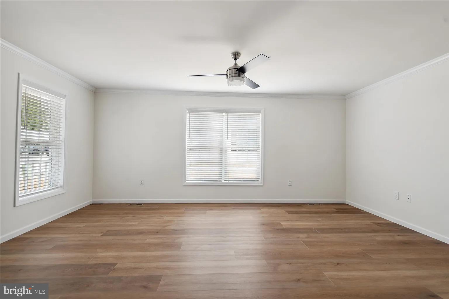2 Ginger Lane Conowingo, MD 21918 - Photo 6 of 27 an empty room with wooden floor chandelier fan and windows