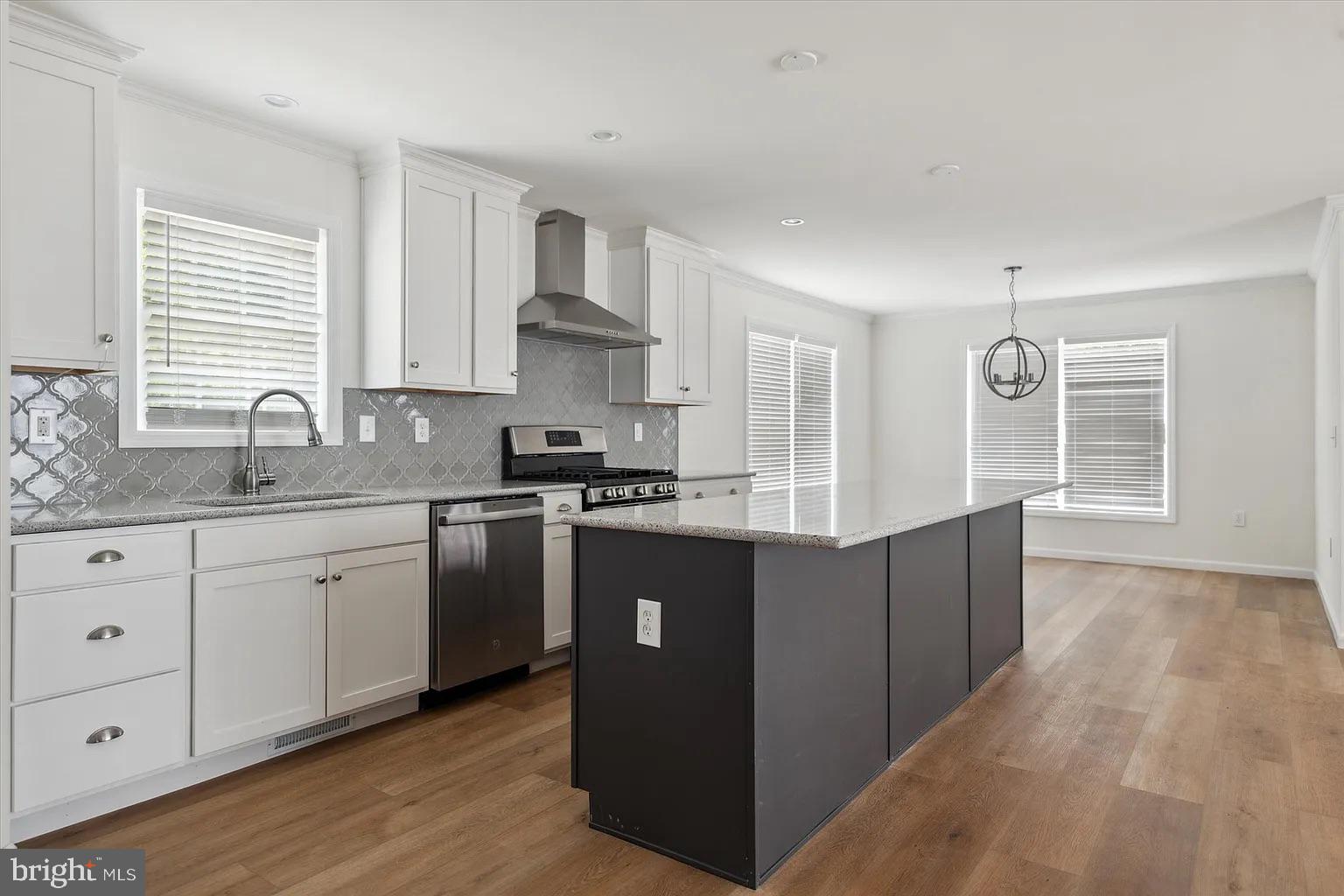 2 Ginger Lane Conowingo, MD 21918 - Photo 8 of 27 a kitchen with kitchen island granite countertop a sink cabinets and wooden floor