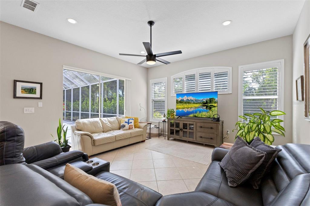 6840 Coyote Ridge Court Bradenton, FL 34201 - Photo 12 of 39 a living room with furniture ceiling fan and a window