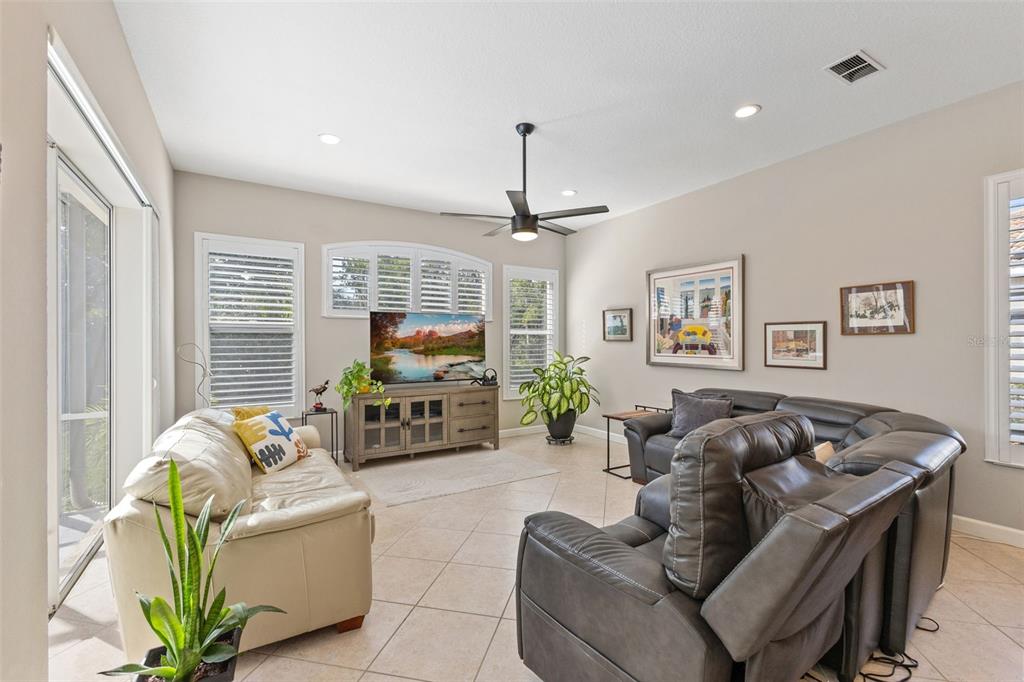 6840 Coyote Ridge Court Bradenton, FL 34201 - Photo 13 of 39 a living room with fireplace furniture and a flat screen tv