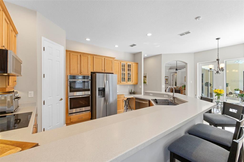 6840 Coyote Ridge Court Bradenton, FL 34201 - Photo 17 of 39 a kitchen with stainless steel appliances granite countertop a refrigerator and a sink