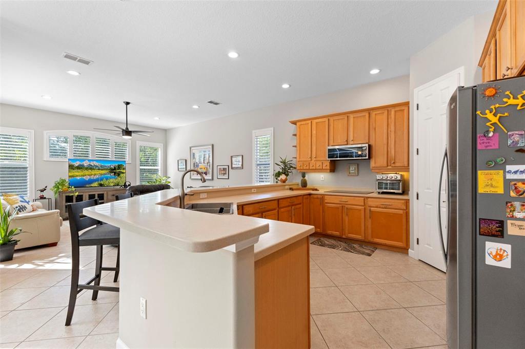 6840 Coyote Ridge Court Bradenton, FL 34201 - Photo 18 of 39 a kitchen with stainless steel appliances kitchen island granite countertop a sink and cabinets