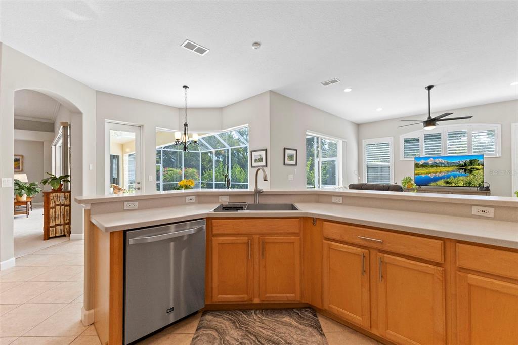 6840 Coyote Ridge Court Bradenton, FL 34201 - Photo 19 of 39 a kitchen with kitchen island granite countertop a sink and a stove
