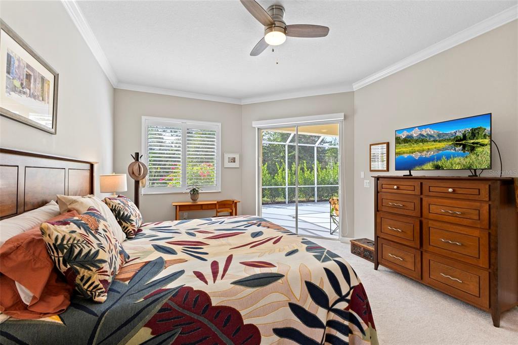 6840 Coyote Ridge Court Bradenton, FL 34201 - Photo 20 of 39 a bedroom with a bed and wooden floor