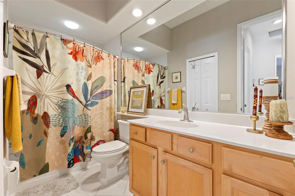 6840 Coyote Ridge Court Bradenton, FL 34201 - Photo 28 of 39 a bathroom with a sink a toilet and a large mirror