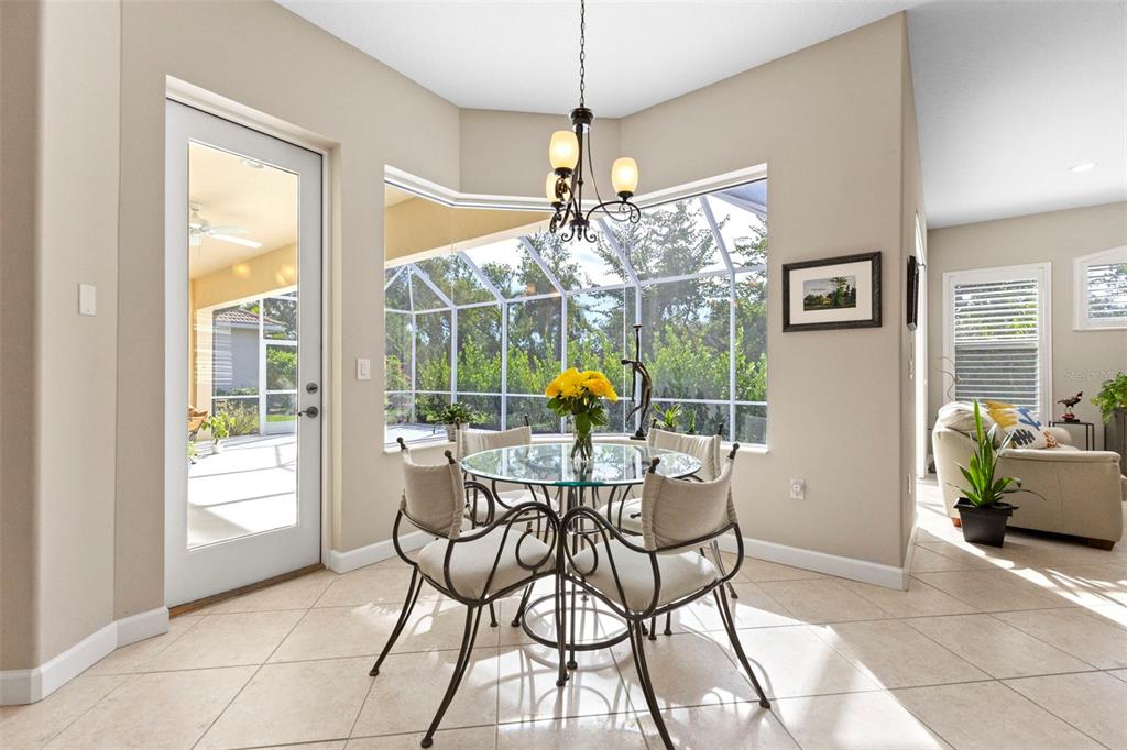 6840 Coyote Ridge Court Bradenton, FL 34201 - Photo 6 of 39 a view of a dining room with furniture wooden floor and a chandelier