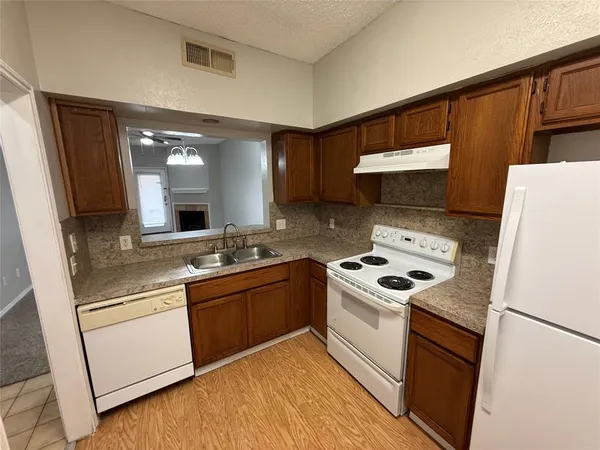 a kitchen with a stove and a refrigerator