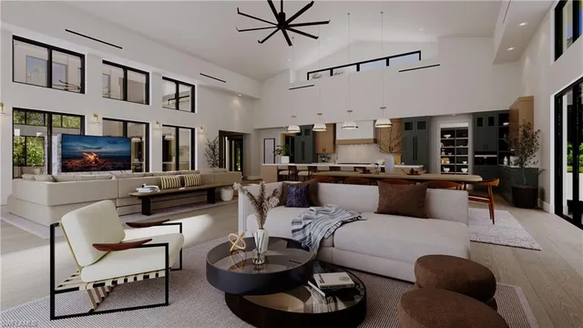 a living room with furniture kitchen view and a window