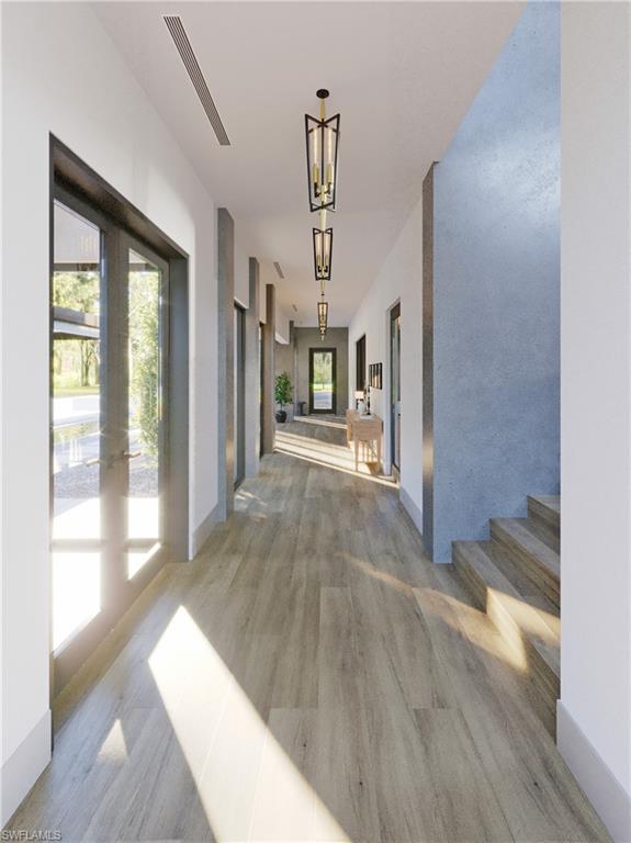 4161 3rd Avenue Southwest Naples, FL 34119 - Photo 7 of 13 a view of a hallway with wooden floor and a living room