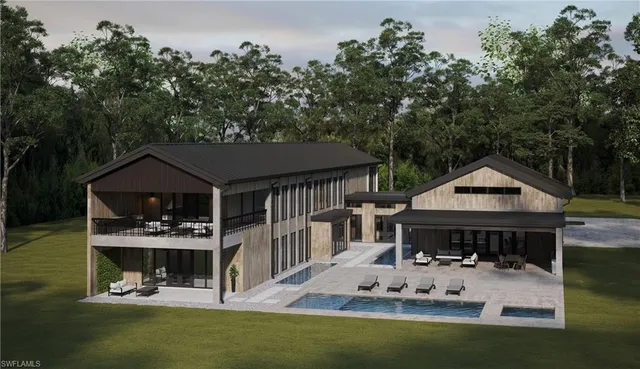 a view of a house with backyard and sitting area