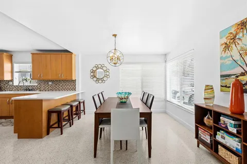 a view of a dining room with furniture and a rug