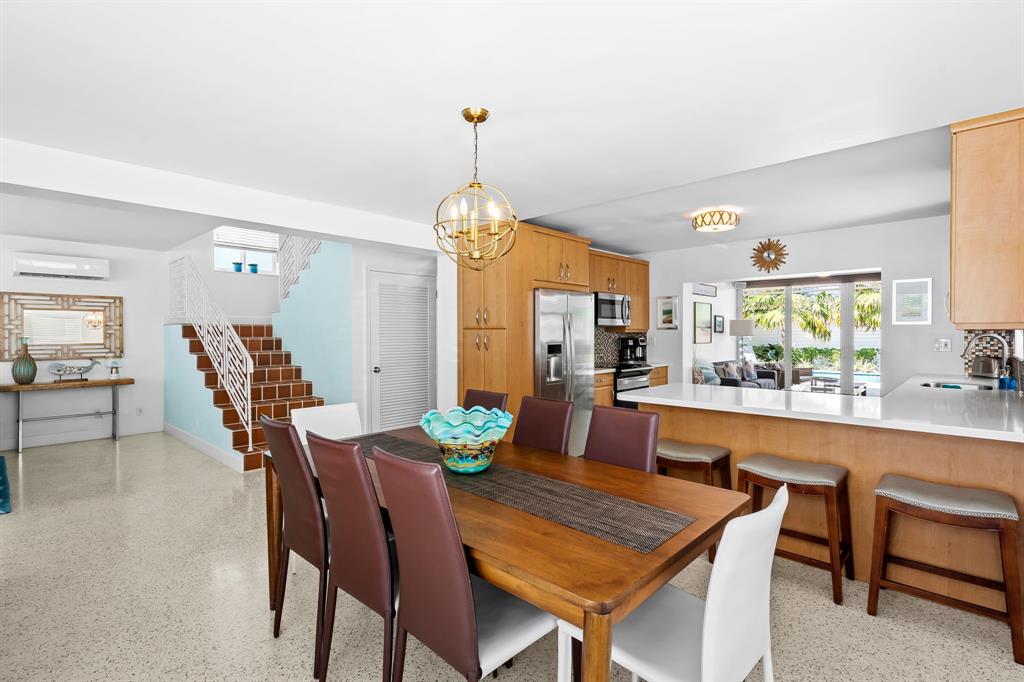 3321 Northeast 16th Court Fort Lauderdale, FL 33305 - Photo 39 of 41 a dining room with furniture a chandelier and wooden floor