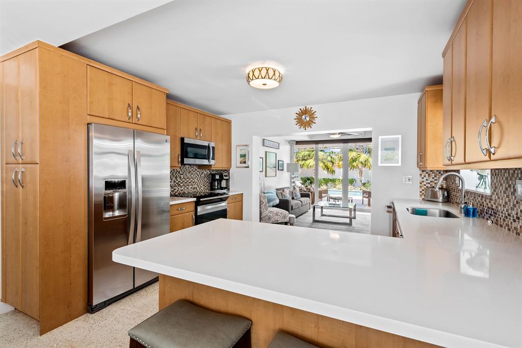 3321 Northeast 16th Court Fort Lauderdale, FL 33305 - Photo 4 of 41 a kitchen with stainless steel appliances a sink a counter cabinets and a window