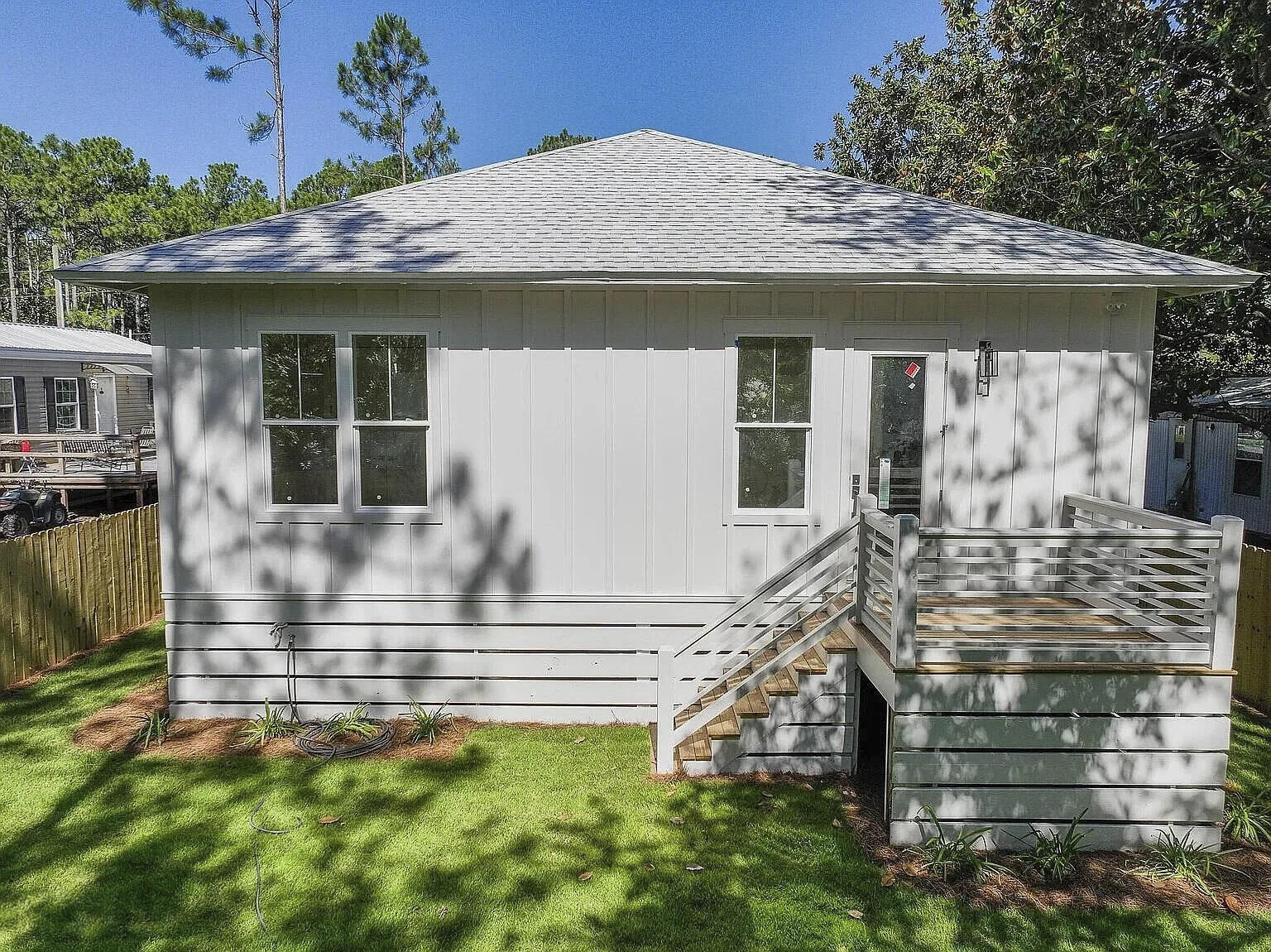 162 7th Street Santa Rosa Beach, FL 32459 - Photo 2 of 13 a front view of a house with a garden