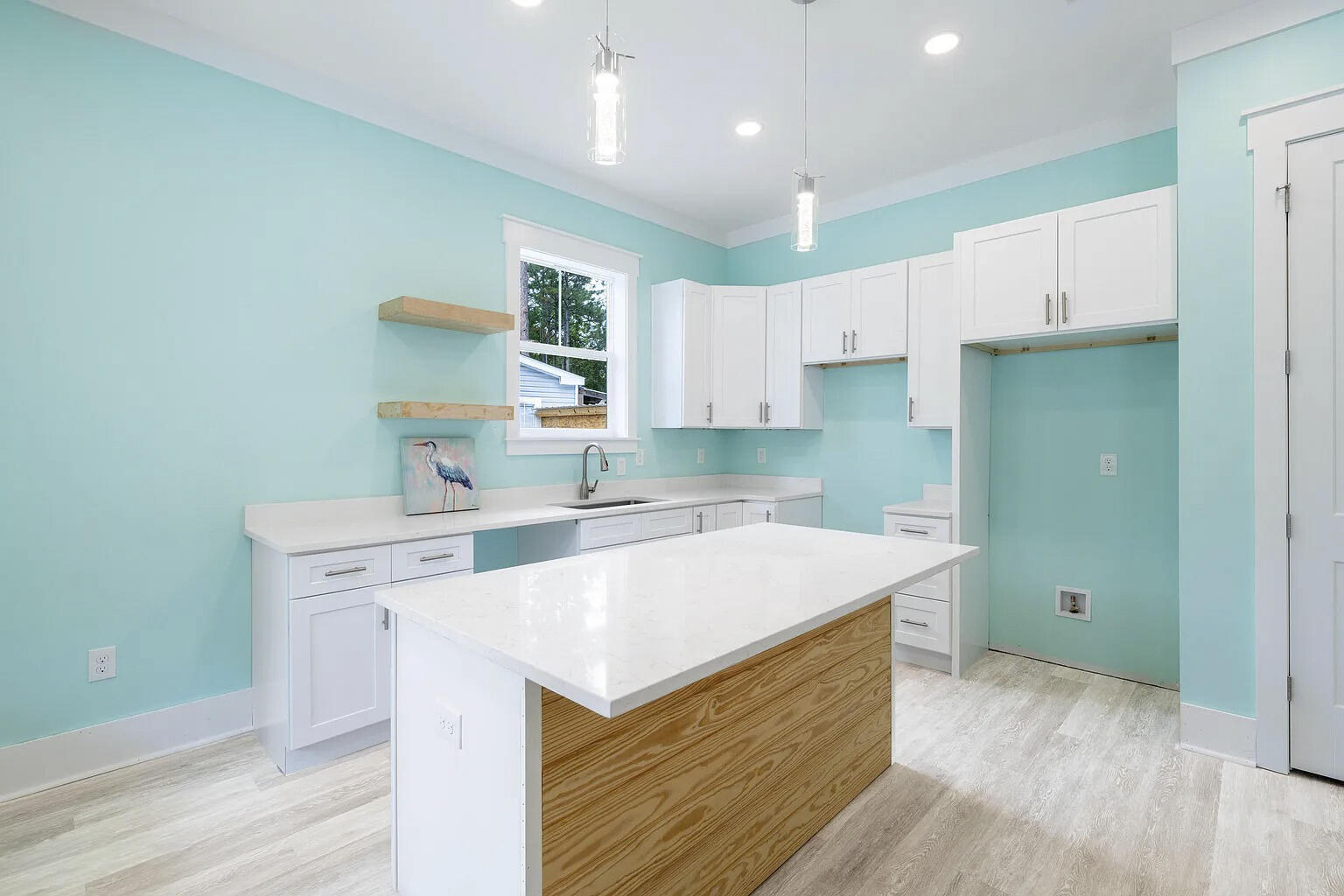 162 7th Street Santa Rosa Beach, FL 32459 - Photo 3 of 13 a kitchen with a sink a stove a refrigerator and white cabinets