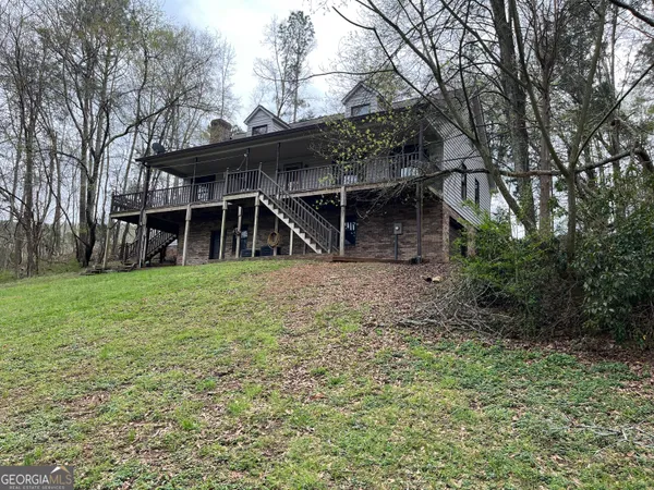 a view of house with yard and seating area