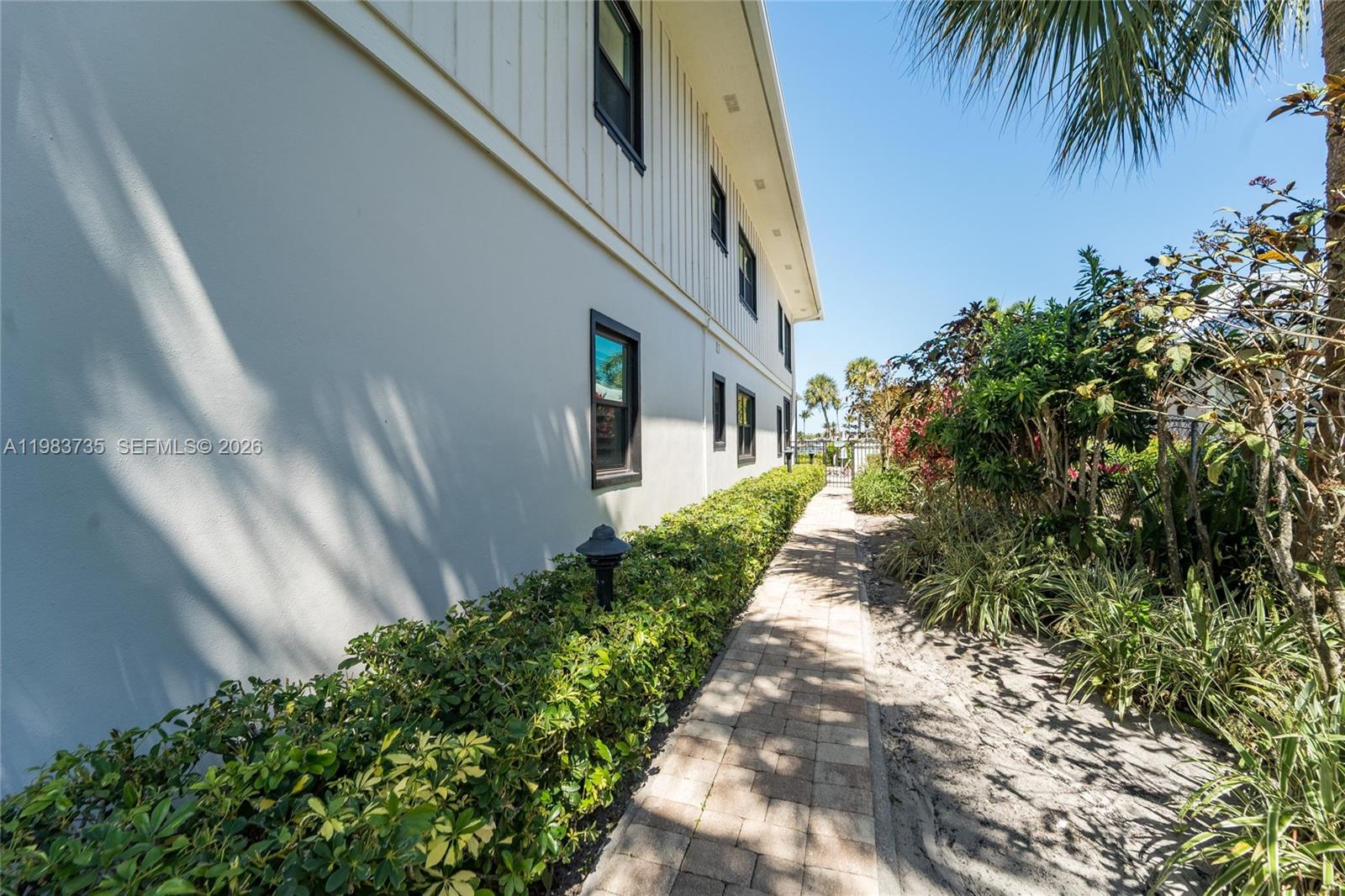 851 Saturn Street, Unit D Jupiter, FL 33477 - Photo 52 of 60 a view of a pathway both side of house