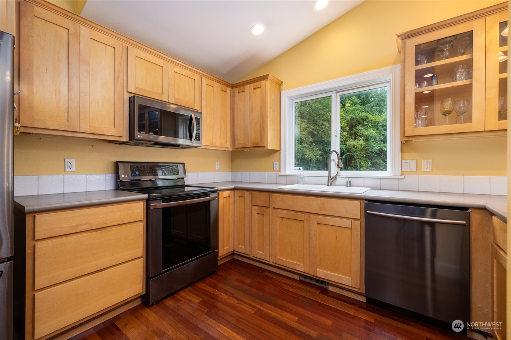835 Alger Cain Lake Road Sedro-Woolley, WA 98284 - Photo 16 of 38 a kitchen with stainless steel appliances granite countertop wooden cabinets a stove a sink and a window