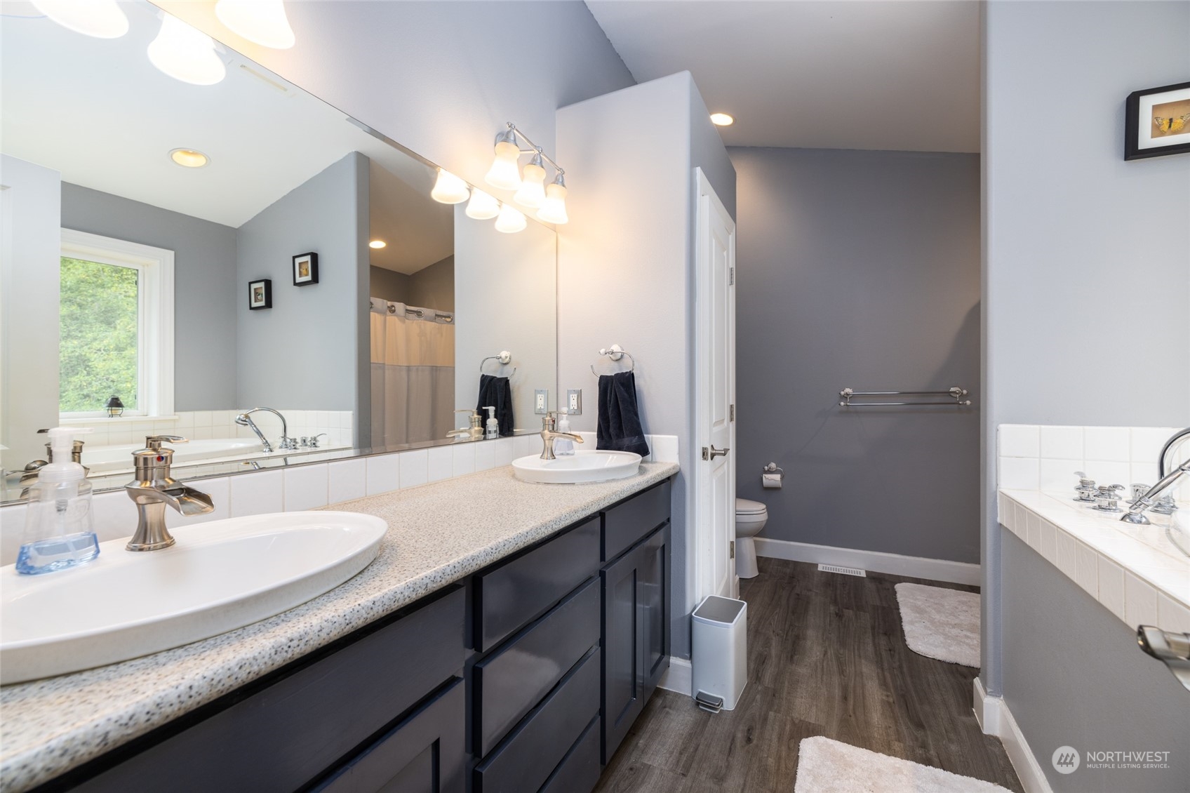 835 Alger Cain Lake Road Sedro-Woolley, WA 98284 - Photo 26 of 38 a bathroom with a sink a toilet and a large mirror