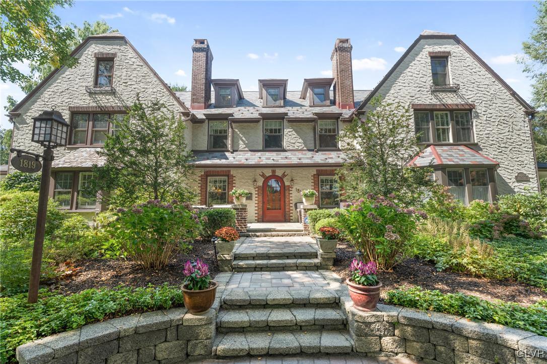 a front view of a house with plants