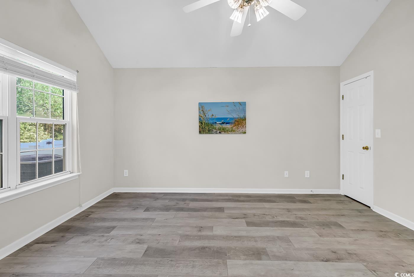 182 Wimbledon Way, Unit 182 Murrells Inlet, SC 29576 - Photo 13 of 37 Empty room with lofted ceiling, a ceiling fan, bas