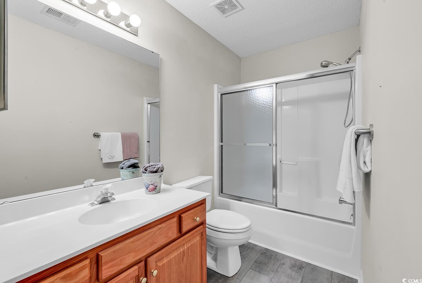 182 Wimbledon Way, Unit 182 Murrells Inlet, SC 29576 - Photo 20 of 37 Full bathroom featuring toilet, vanity, visible ve