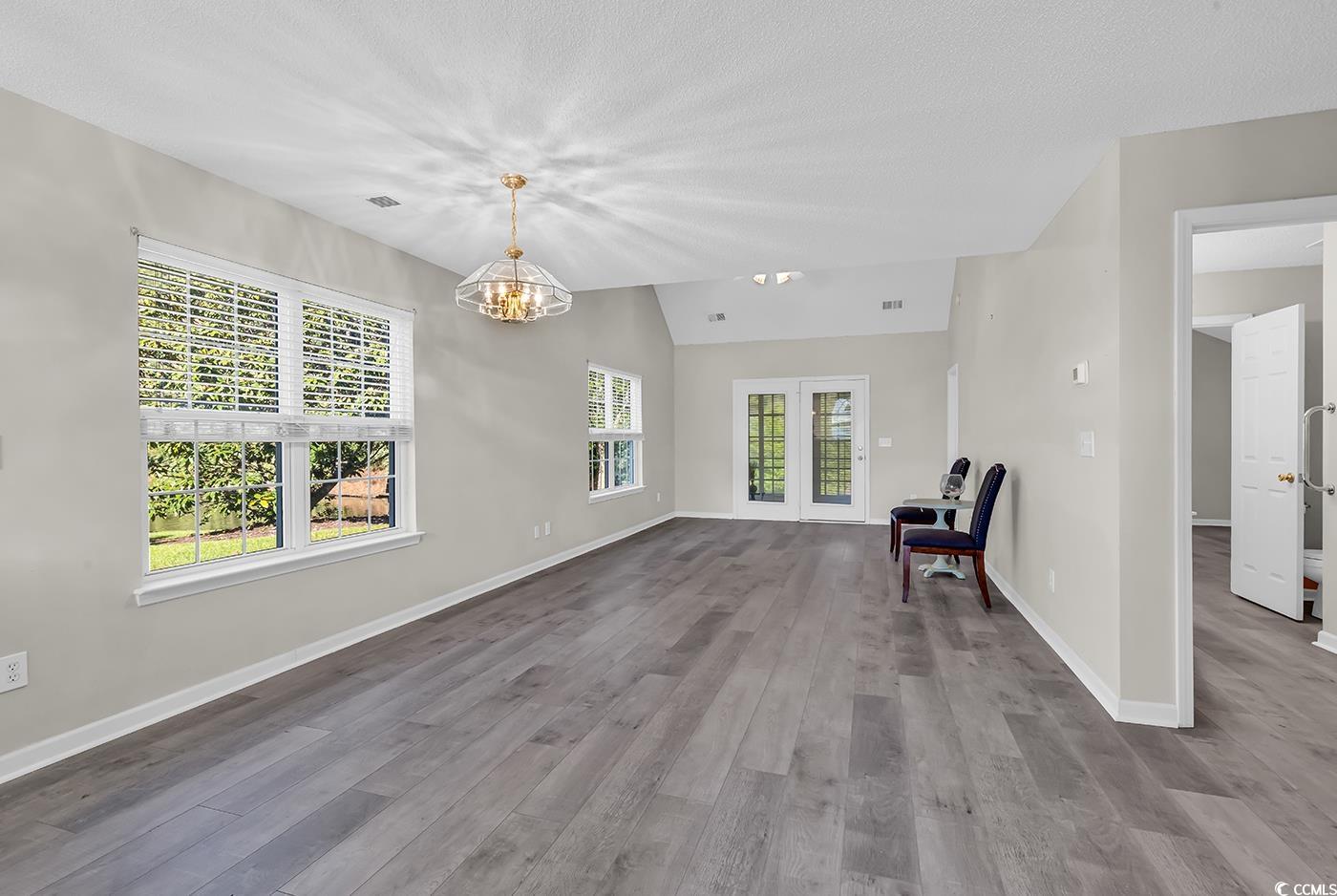 182 Wimbledon Way, Unit 182 Murrells Inlet, SC 29576 - Photo 8 of 37 Unfurnished room featuring vaulted ceiling, wood f