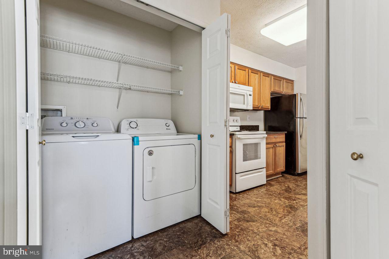 9727 Reese Farm Road, Unit 9727 Owings Mills, MD 21117 - Photo 28 of 32 a view of washer and dryer with bathroom in the background