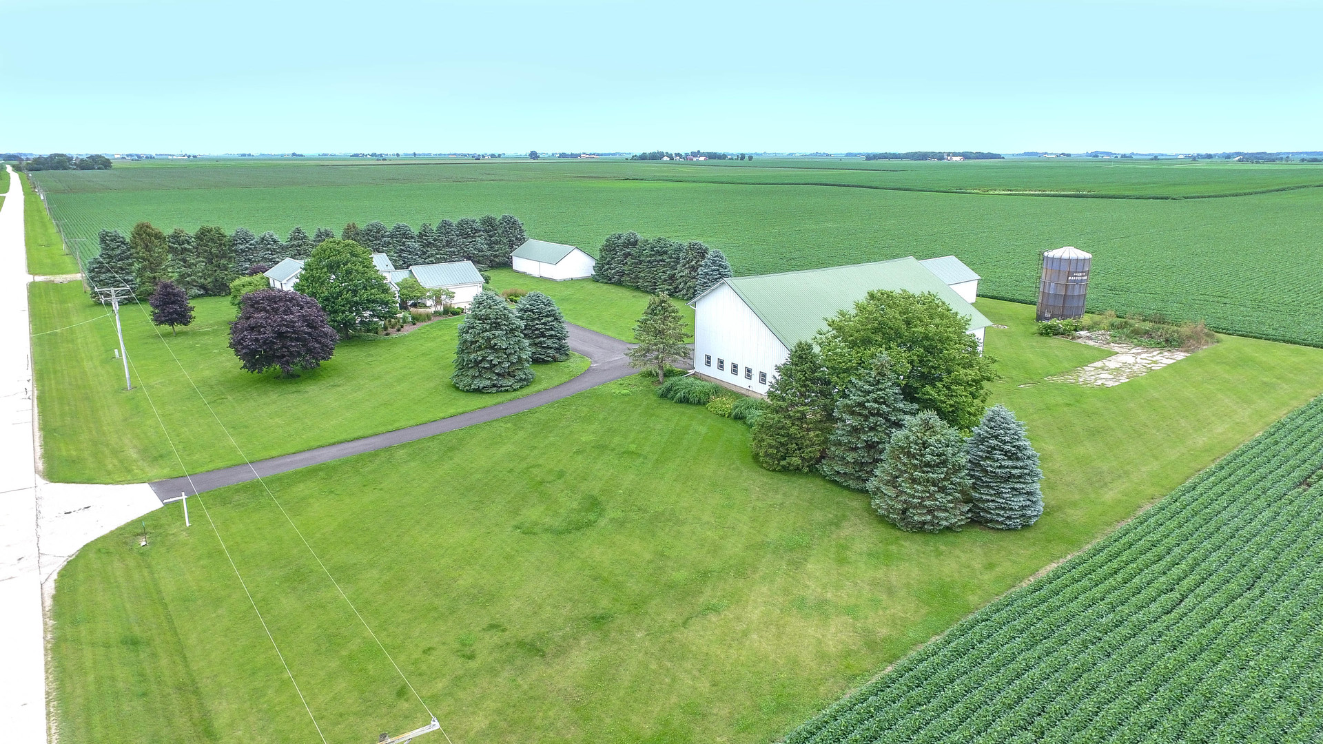 10732 Rimsnider Road Hinckley, IL 60520 - Photo 2 of 44 a green field with lots of green space and trees in the background
