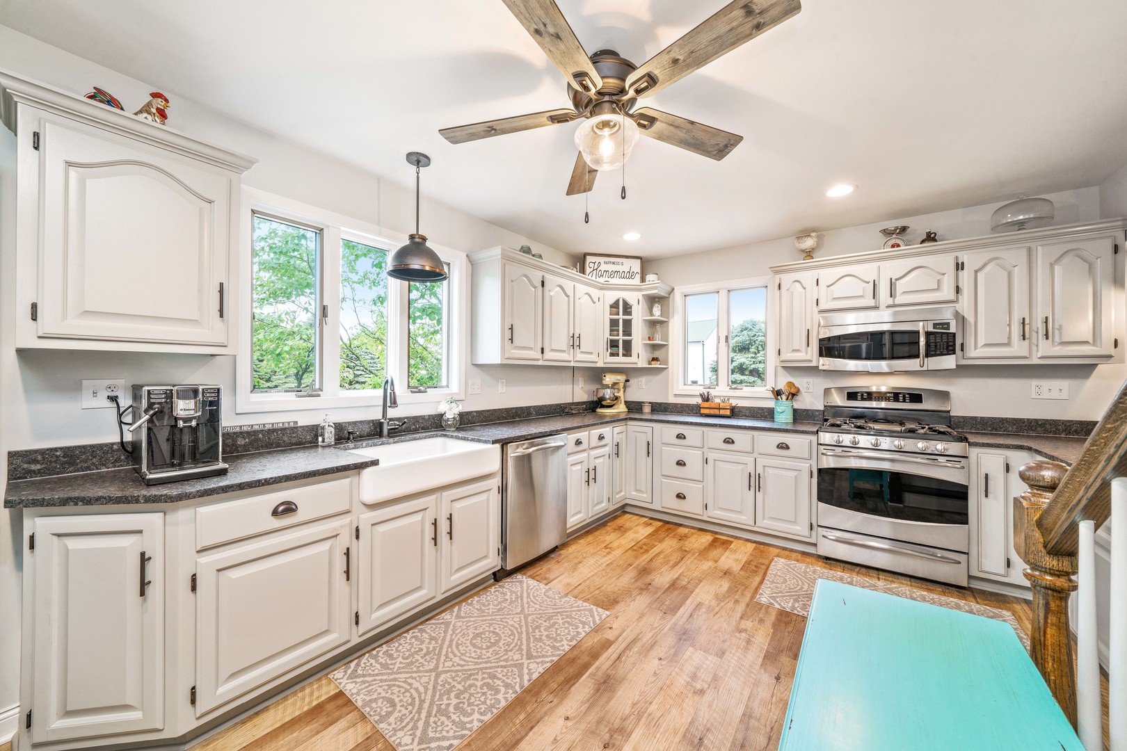 10732 Rimsnider Road Hinckley, IL 60520 - Photo 13 of 44 a kitchen with stainless steel appliances granite countertop a stove top oven a sink a window and white cabinets