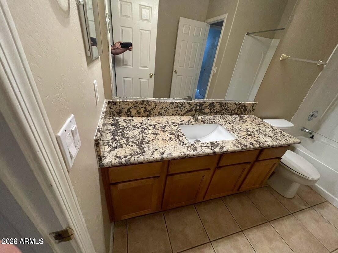 3095 East Merlot Street Gilbert, AZ 85298 - Photo 12 of 13 a bathroom with a granite countertop sink and a mirror