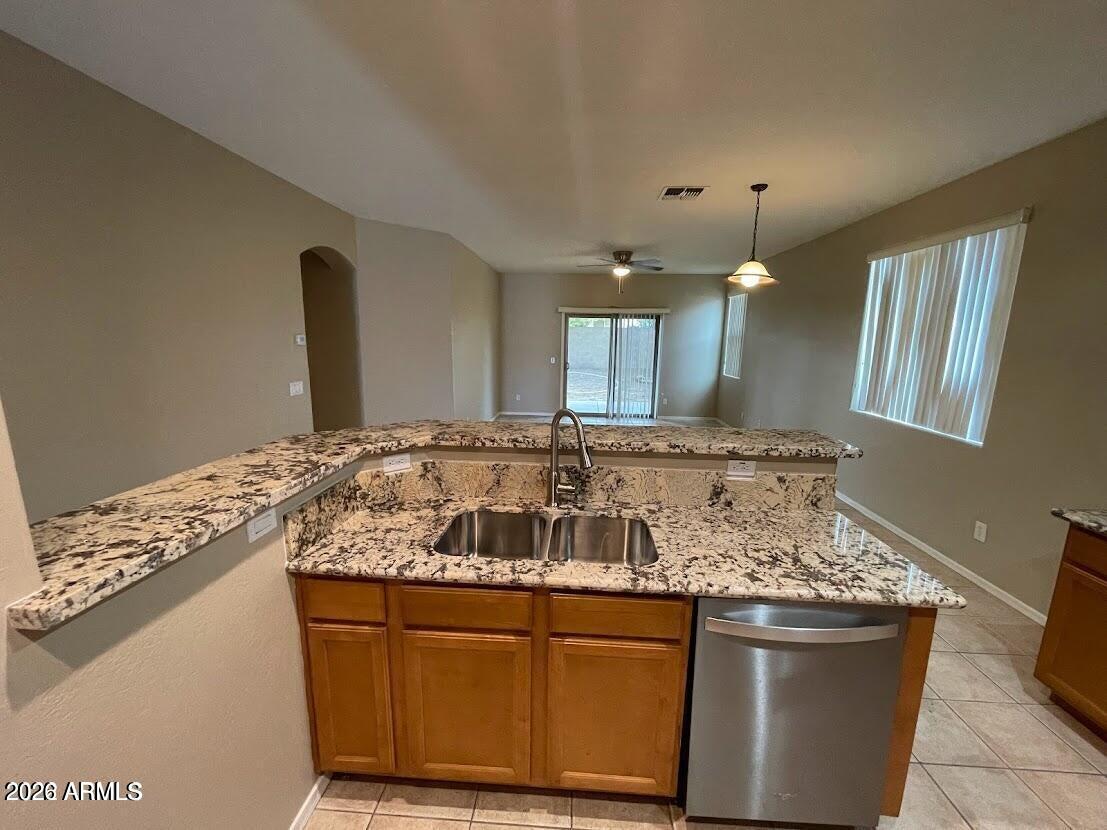 3095 East Merlot Street Gilbert, AZ 85298 - Photo 5 of 13 a kitchen with granite countertop a sink and cabinets