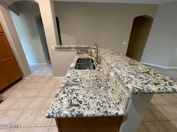 a kitchen with a stove a refrigerator and a sink