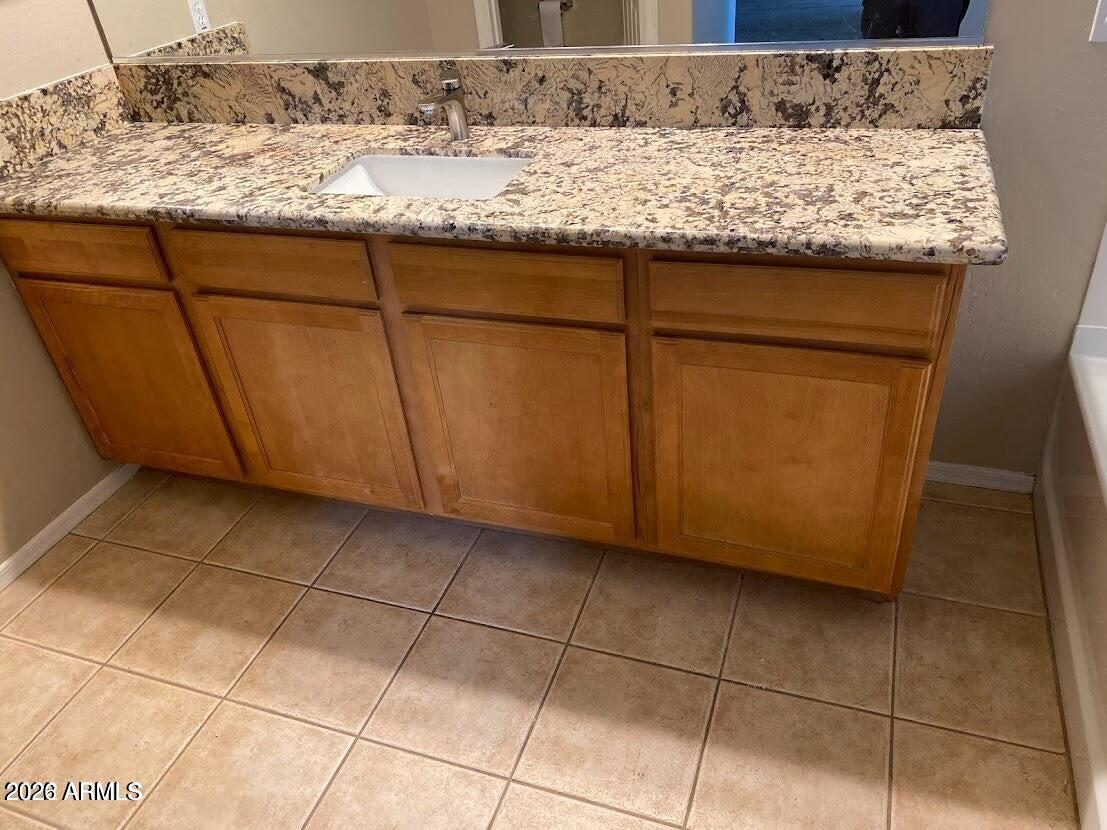 3095 East Merlot Street Gilbert, AZ 85298 - Photo 10 of 13 a bathroom with a granite countertop sink and a mirror