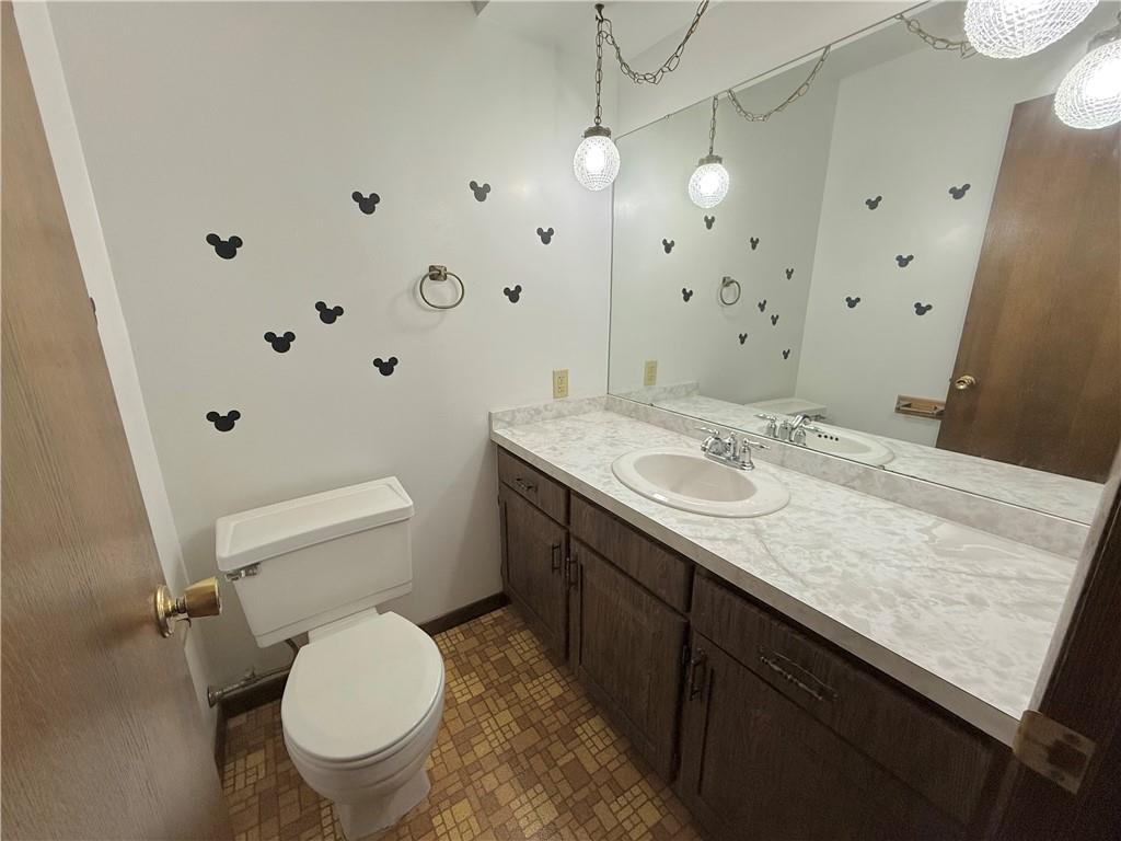 841 East Lutton Street New Castle, PA 16101 - Photo 8 of 12 a bathroom with a granite countertop sink a toilet and a mirror