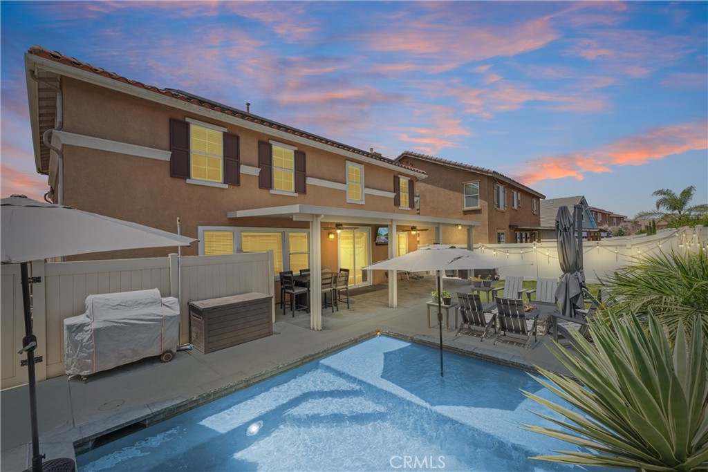 3101 Clapper Street Perris, CA 92571 - Photo 1 of 1 a view of a patio with dining table and chairs with wooden floor and fence