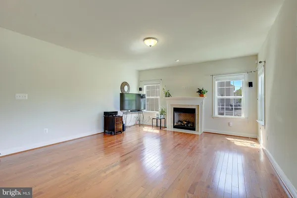a very nice looking room with wooden floor and a chandelier
