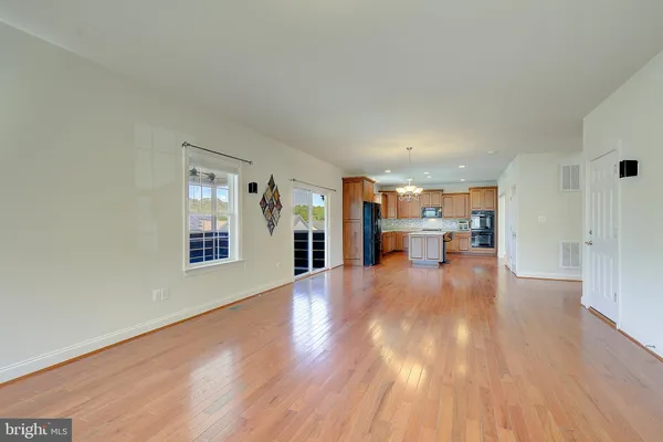 a view of a room with wooden floor and windows