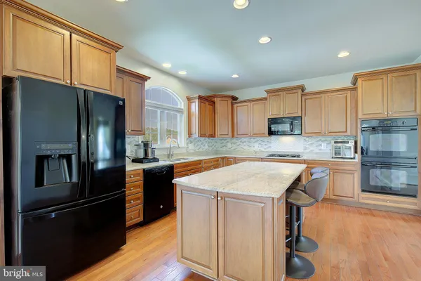 a stove top oven sitting inside of a kitchen